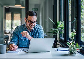 Man reading FAQs on his laptop